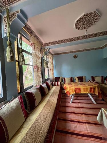 a living room with a table and chairs in it at skoura in Skoura