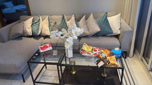 a living room with a couch and a glass table at Apartment suite in Manama