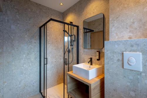 a bathroom with a sink and a shower at MyLiving - Hotel B&B in San Lorenzo di Sebato