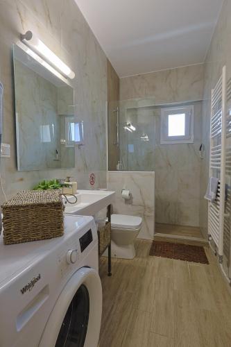 a bathroom with a washing machine and a sink at SIGMA - Signature Living & Easy Parking by Optimum Link in Katerini