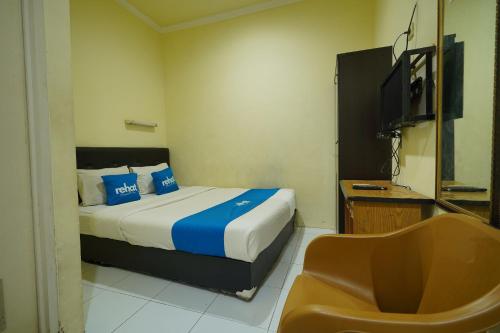 Ένα ή περισσότερα κρεβάτια σε δωμάτιο στο Rehat at Wahidin Guest House