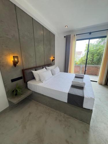 Ένα ή περισσότερα κρεβάτια σε δωμάτιο στο Oasis Mirissa