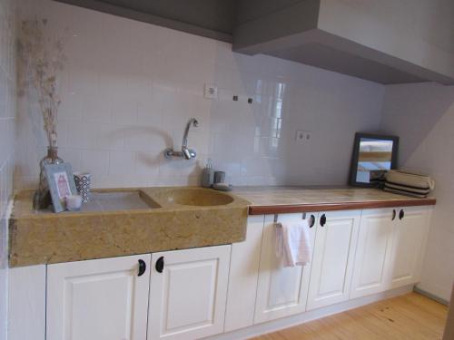 a kitchen with a sink and a counter top at Most Art Boutique Hostel in Leiria