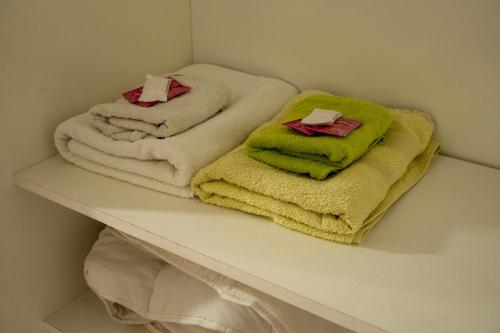 two towels sitting on a shelf in a bathroom at Keóken - Frente al Hiper Tehuelche in Caleta Olivia