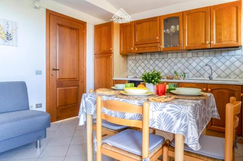a kitchen with a table with two chairs and a blue couch at Casa Torre di Nora - Morada in Pula