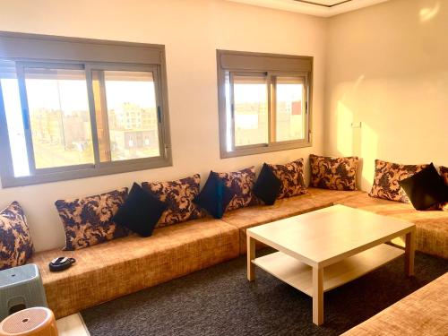 a living room with a couch and a table at Dakhla sky blue in Dakhla