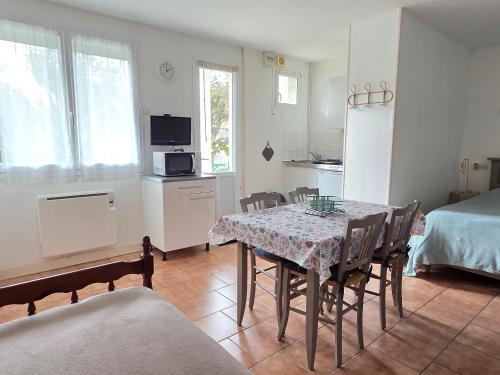 a kitchen and dining room with a table and chairs at Studio cosy avec jardin et WIFI à La Roche-Posay - FR-1-541-187 in La Roche-Posay
