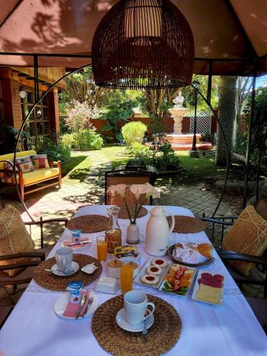 a table with plates of food and drinks on it at Casa Emiluz in La Serena