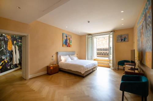 a bedroom with a bed and a large window at Galleria Vik Milano - Townhouse Galleria - Small Luxury Hotels of the World in Milan