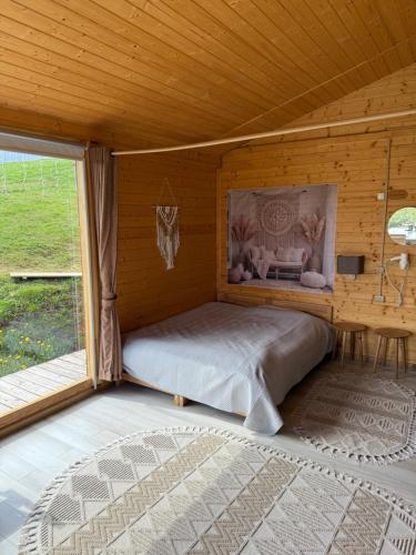 a bedroom with a bed in a wooden room at Berdo Svaliava in Svalyava
