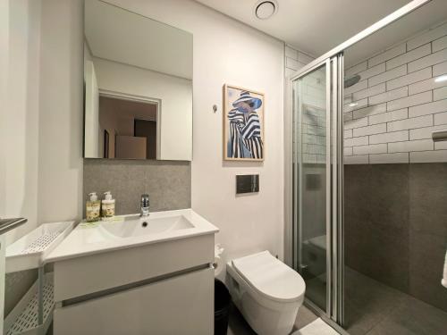 a bathroom with a sink and a toilet and a shower at Luxury Apartment Unit 111 Le Jardin in George