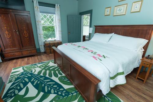 a bedroom with a bed with a white comforter at Old Furnace Inn in Harrisonburg