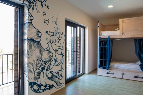 a room with a mural of an elephant on the wall at WOT Ericeira Surf Social in Ericeira