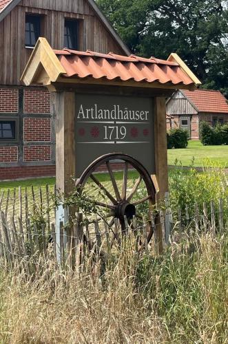 a sign for an antricular house with a waterwheel at Artlandhaus 1719 - Geschichte trifft Moderne in Menslage