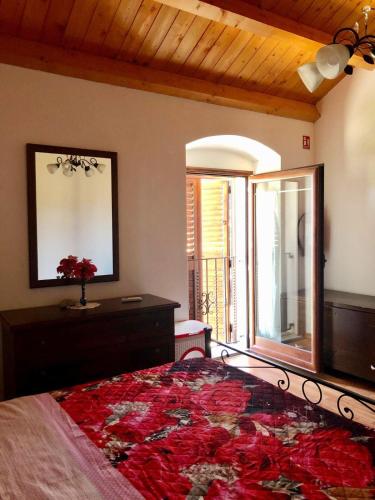 a bedroom with a bed and a mirror and a window at Casa relax Nasiu in Perdaxius