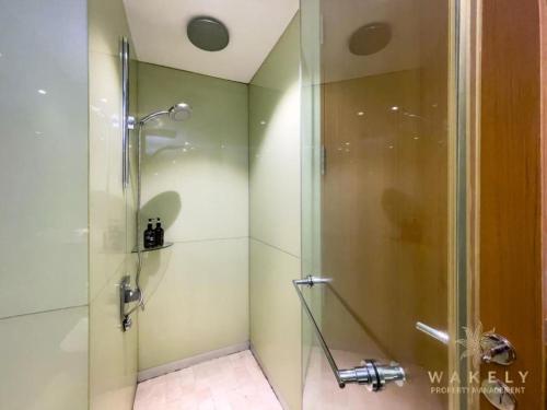 a bathroom with a shower with a glass door at Sky Suite KLCC By SkyLights in Kuala Lumpur