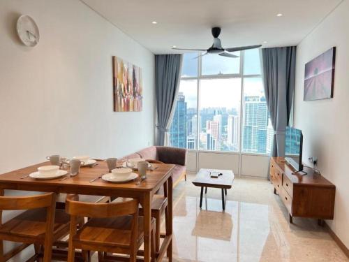a living room with a table and a couch at Sky Suite KLCC By SkyLights in Kuala Lumpur