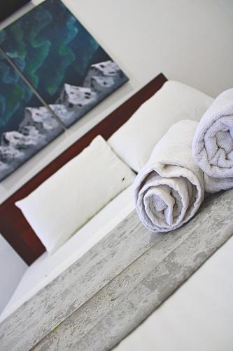 a pile of rolled towels sitting on a table at Savendro Villa Hikkaduwa in Hikkaduwa
