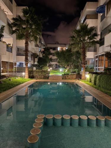 a swimming pool in a hotel at night at Luxury and serenity HARHOURA in Temara