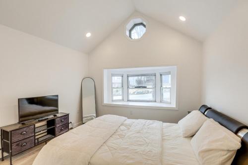 a bedroom with a bed and a tv and a window at Home with Lake Views and Deck in New Jersey Highlands! in Stanhope