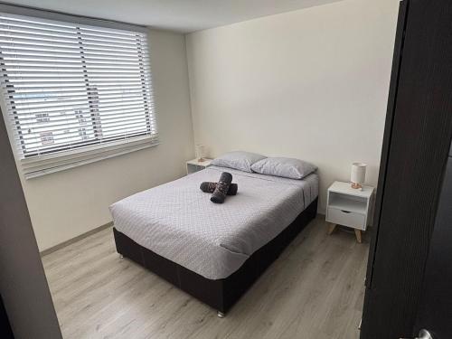 a bedroom with a bed with a teddy bear on it at Estancia del Volcán in Santa María Coronanco