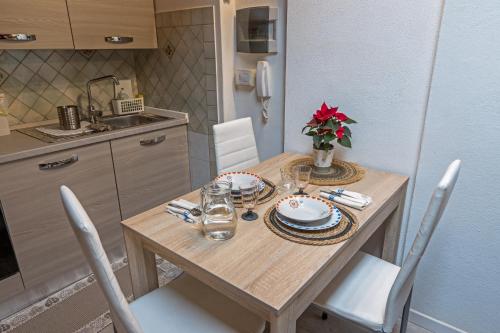 a kitchen with a wooden table with chairs and a dining room at Casa di Rosy in San Sperate