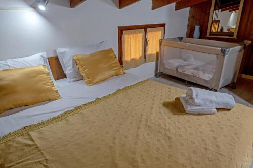 a bedroom with a large bed and a sink at Casa di Rosy in San Sperate