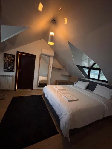 a bedroom with a large white bed and a window at Ibiza in Batroûn