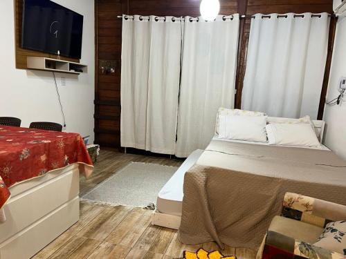 En eller flere senge i et værelse på Canto Gira Sol - Estúdio Girassol