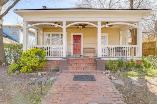 a yellow house with a red door and a porch at Charming 3 bedroom Home in Decatur