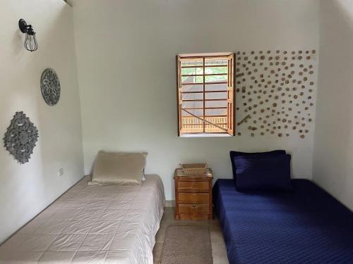 a bedroom with two beds and a window at Finca El Cural in Sasaima