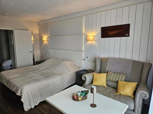 a bedroom with a bed and a couch at studio, Anglet Chiberta ocean golf surf in Anglet