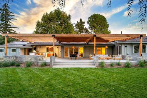 a wooden pergola on a house with a yard at Ojai Valley - Pool and Pickle Ball in Ojai