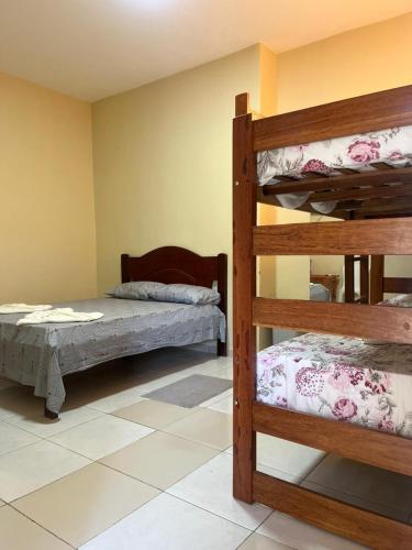a bedroom with two bunk beds in a room at Pousada BG Lençóis in Barreirinhas