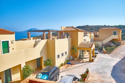 a house with a car parked in the driveway at Element Hotel in Elafonisos