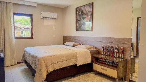 En eller flere senge i et værelse på Aconchegante Casa em Ipioca Jeunne Ville