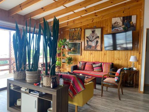 a living room with couches and plants in it at Casa Tongoy Península in Coquimbo