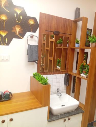 a bathroom with a sink and a mirror at Gurunandanam-Fully furnished Deluxe Apartment East Nada Guruvayur in Guruvāyūr