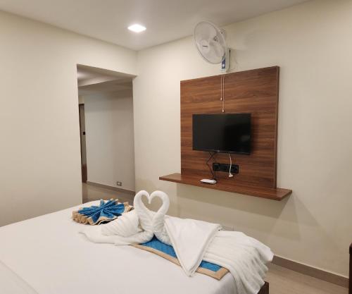 Postel nebo postele na pokoji v ubytování Visthara Elite