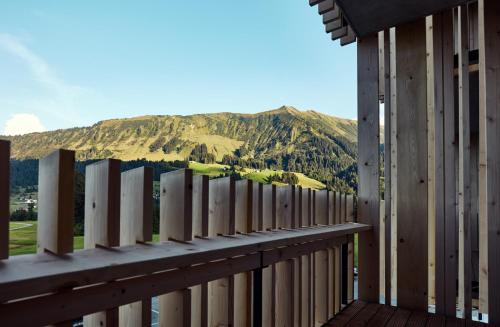 a balcony with a view of a mountain at Genuss- & Aktivhotel Sonnenburg in Riezlern