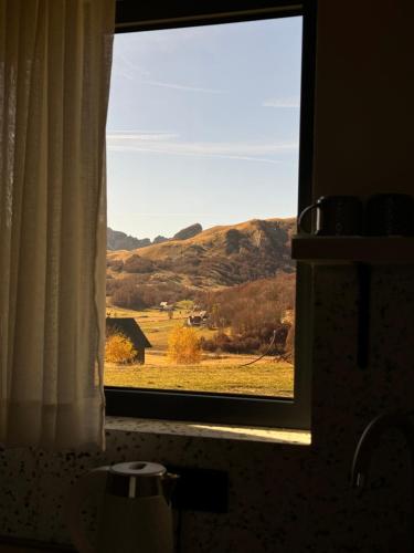a window in a bathroom with a view of a field at Monte zone in Žabljak