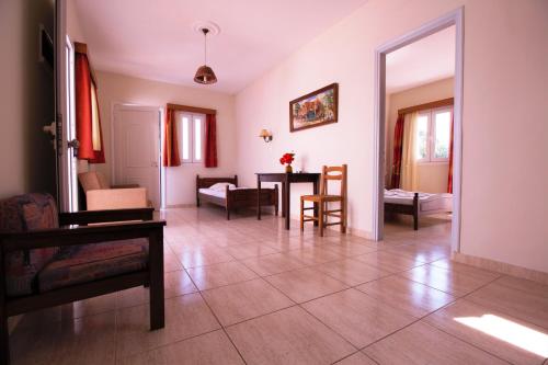 a living room with a table and chairs at Ampavris Family Apartments in Kos Town