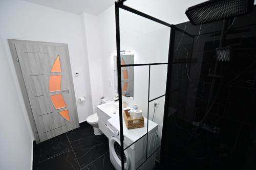 a bathroom with a sink and a mirror at FLH - Moonwalk in Sibiu