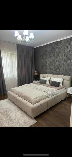 a large bed in a bedroom with a large bed frame at Guest House Amaya in Plovdiv