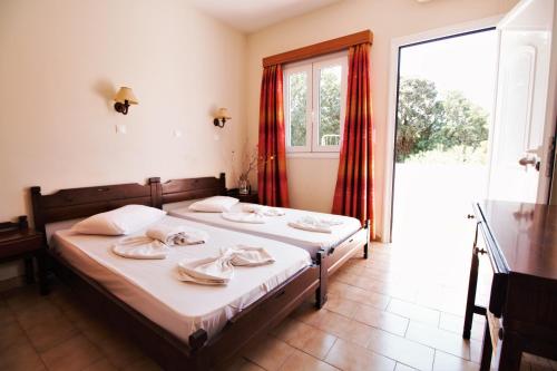 a bedroom with a bed with towels on it at Ampavris Family Apartments in Kos Town