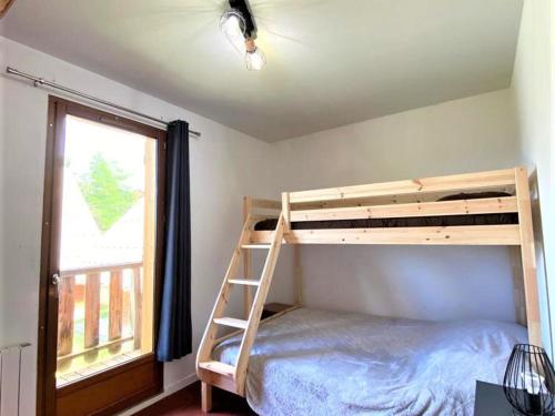 a bedroom with a bunk bed and a window at Chalet Mitoyen 3 Pièces, 7 Pers, Résidence Les Flocons du Soleil, La Joue du Loup - FR-1-863-12 in Le Dévoluy