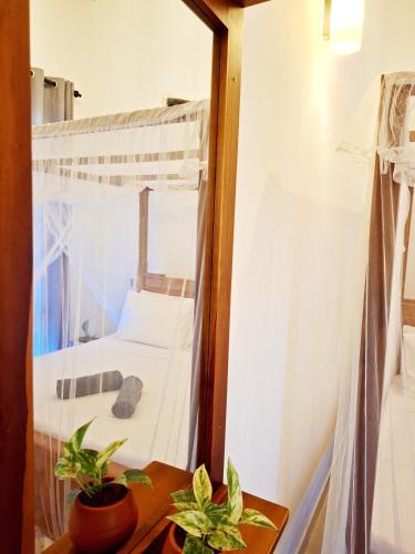 a small room with a bed and a mirror at Mangrove Inn Mirissa in Kamburugamuwa