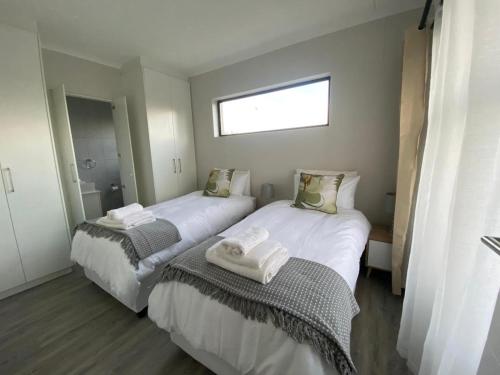 En eller flere senge i et værelse på Coastal Apartments