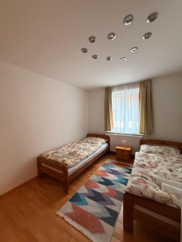a bedroom with two beds and a rug at Wohnung in Hüttau in Sonnberg