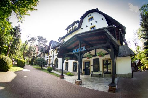 a building with awning on a brick street at Hotel Maria in Strzelin